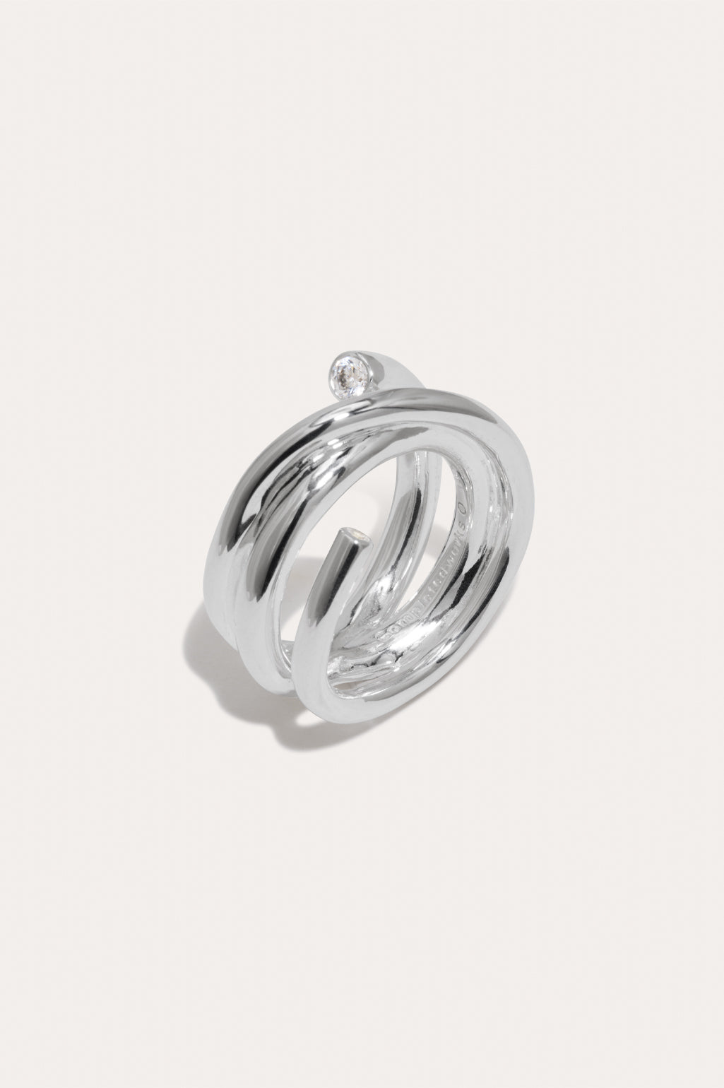 Completed Works Coil zirconia and recycled silver vermeil ring featuring two white zirconia stones in a sculptural wrap design at Alas Eius