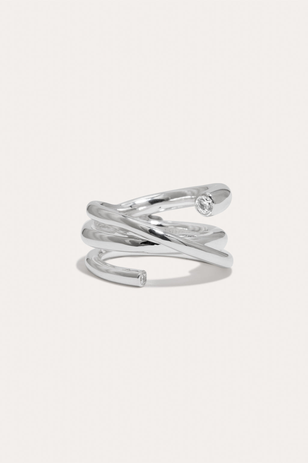 Completed Works handcrafted recycled silver vermeil Coil ring with two white zirconia stones and a contemporary sculptural silhouette at Alas Eius