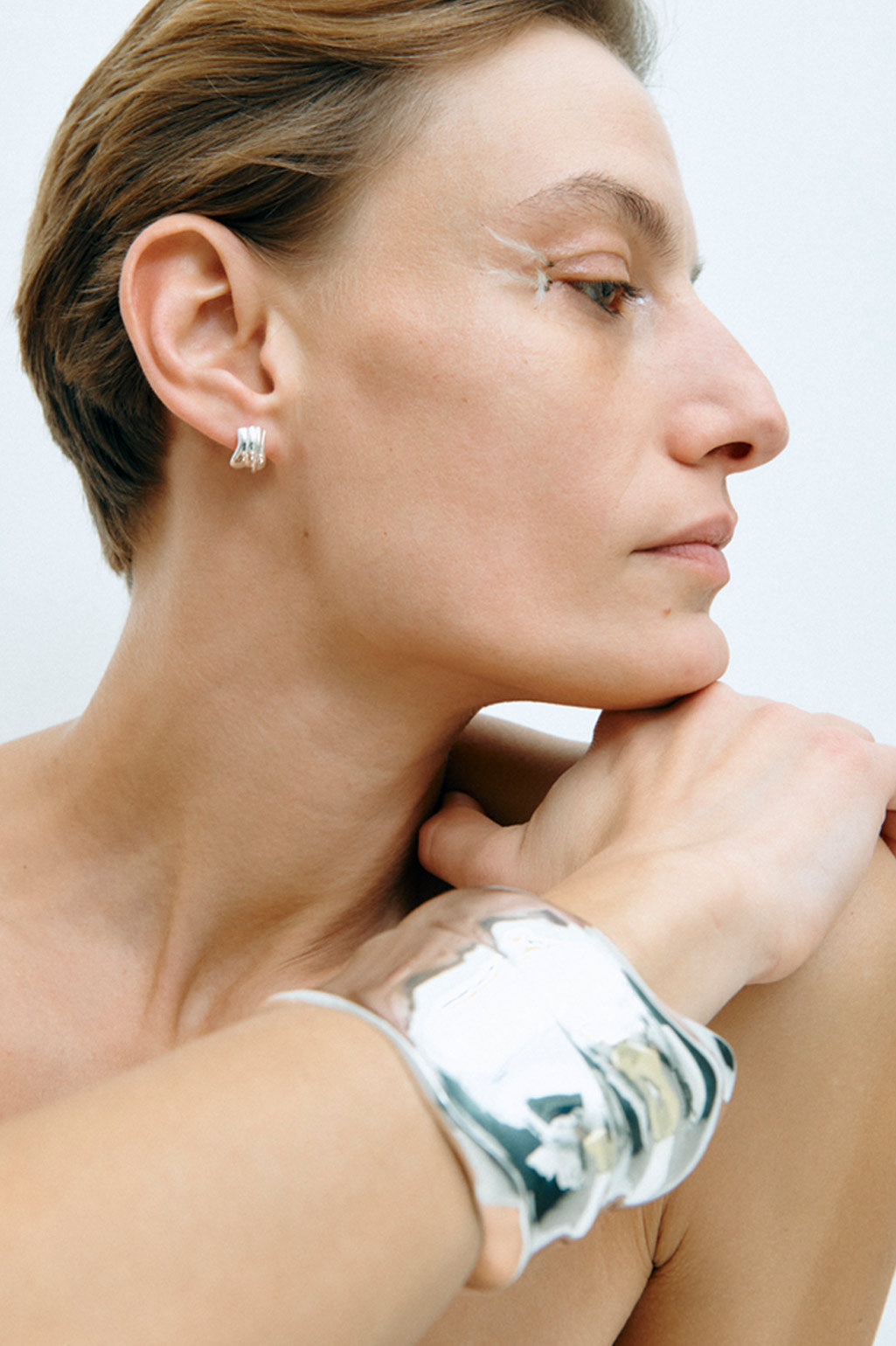 Completed Works handcrafted Foreshore recycled sterling silver plated statement cuff with an open sculptural design at Alas Eius