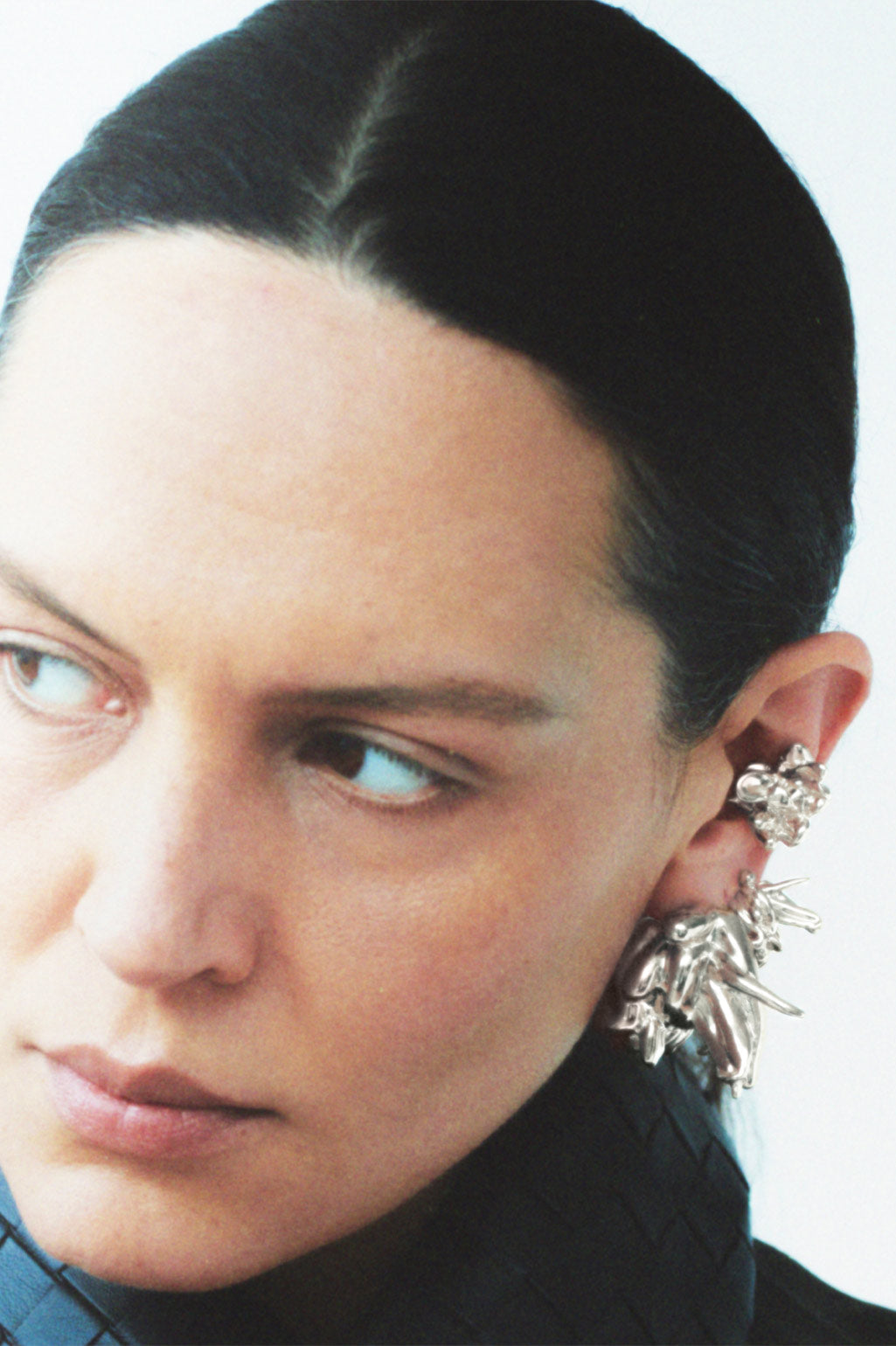 Completed Works handcrafted silver plated recycled brass earrings with an organic sculptural form inspired by the quiet defiance of shape at Alas Eius