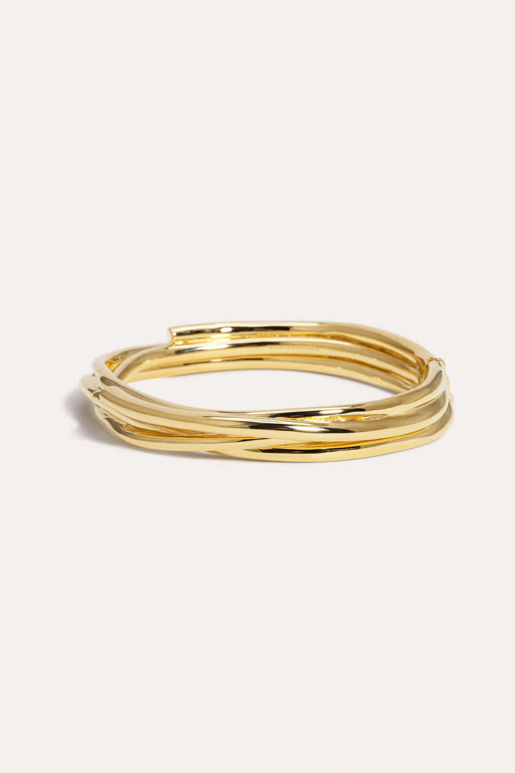 Completed Works Shifting Ground Beneath Our Feet 18ct yellow gold plated brass bangle with a sculptural wrap silhouette at Alas Eius