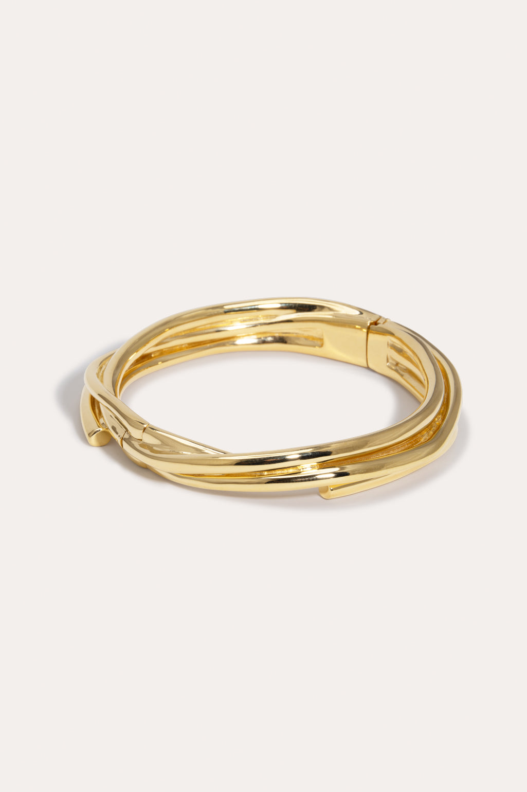 Completed Works sculptural 18ct yellow gold plated brass bangle designed to wrap elegantly around the wrist at Alas Eius