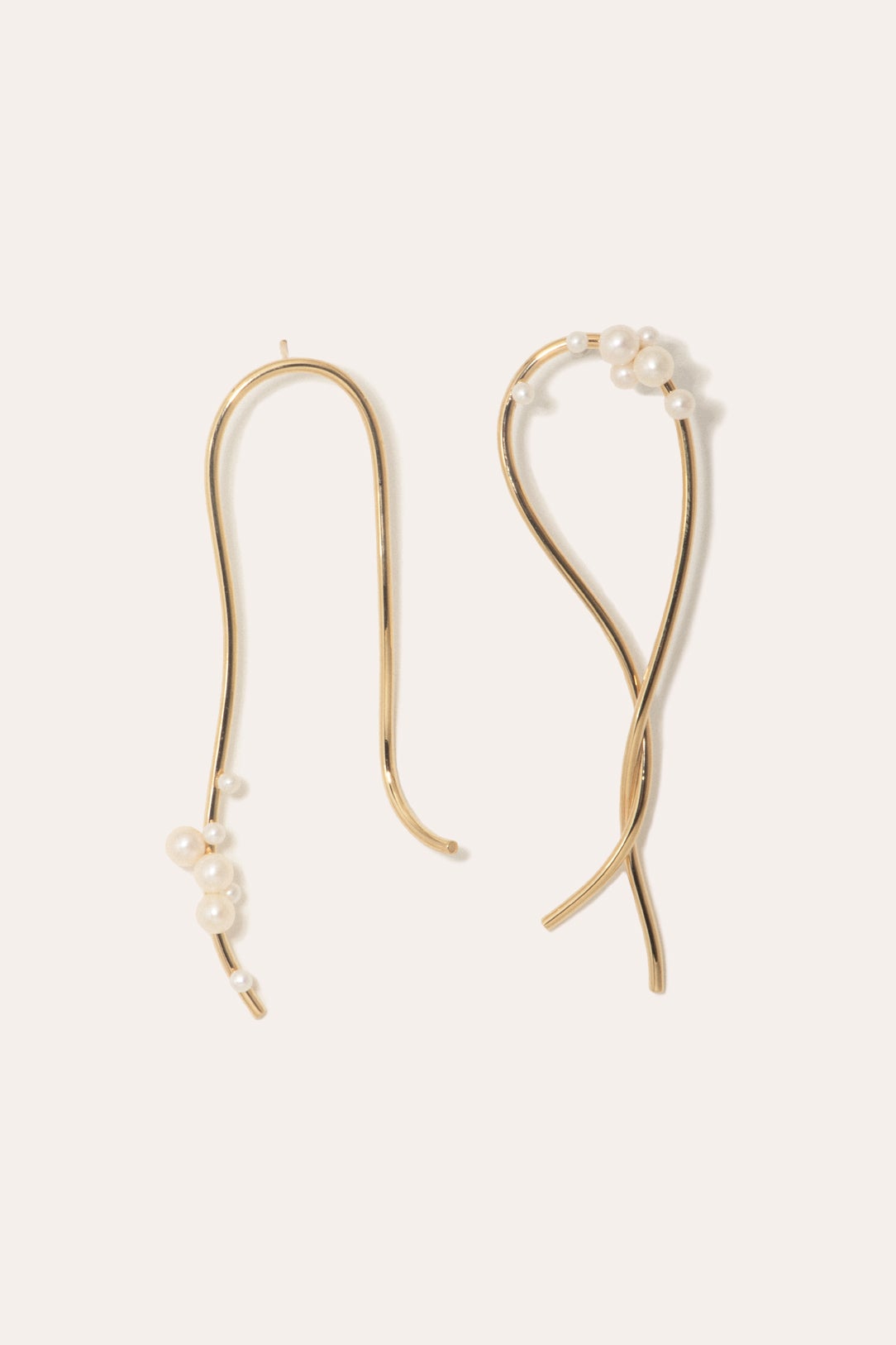 Completed Works Wild Relatives pearl and 14ct yellow gold vermeil earrings featuring freshwater pearls with a sculptural cascading silhouette at Alas Eius