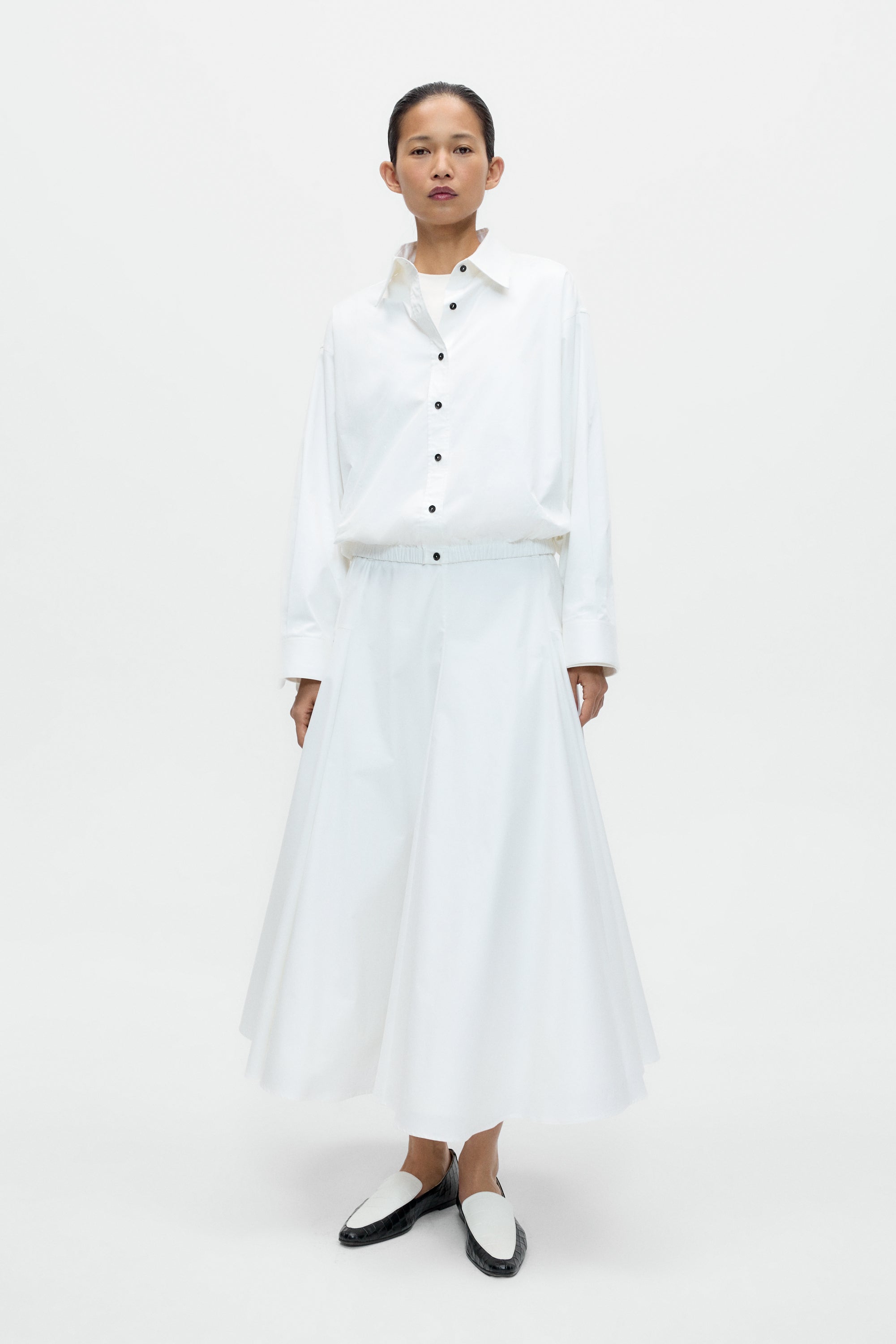 Cordera oversized white shirt with Italian collar and black buttons at Alas Eius