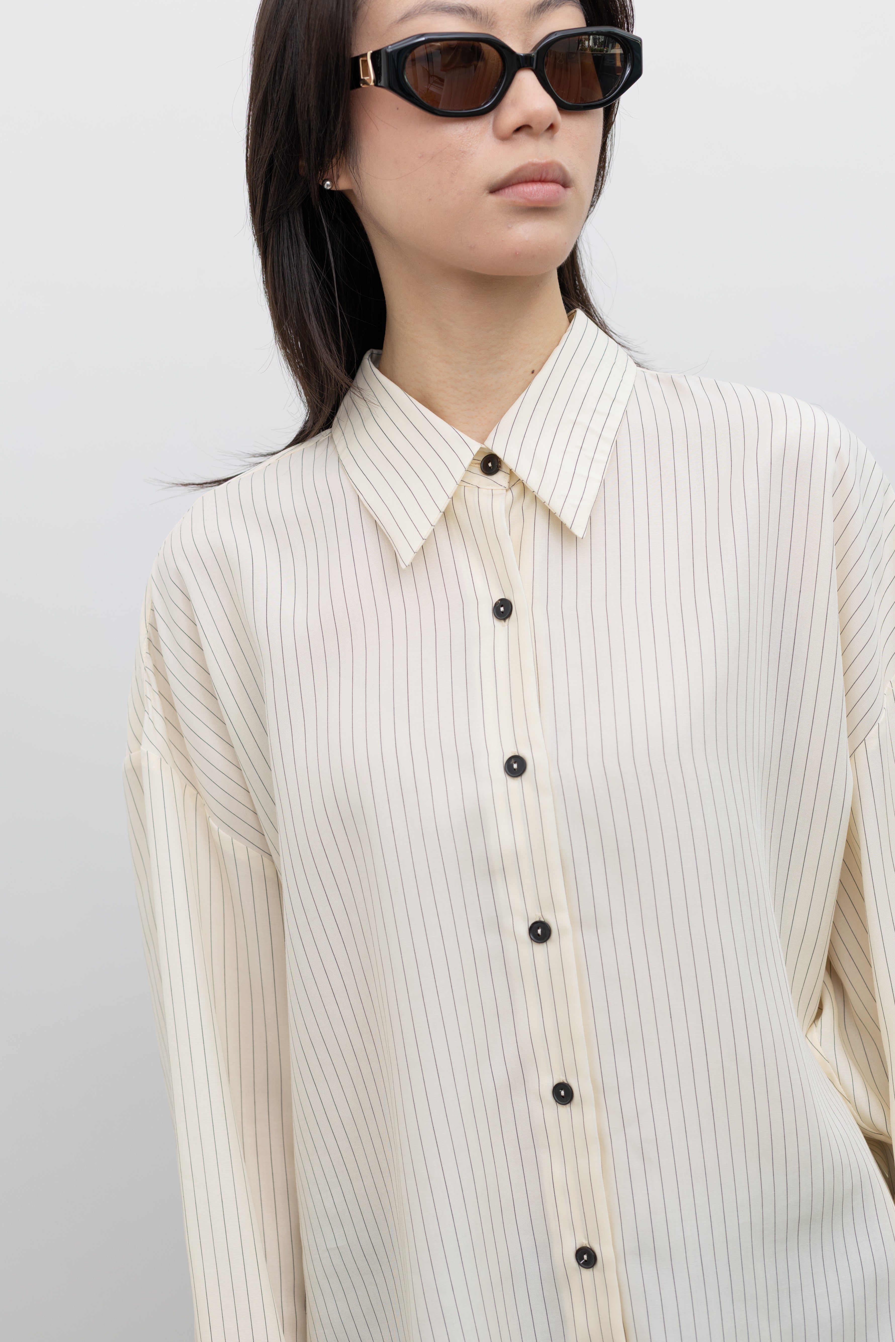 Cordera oversized striped shirt styled as a versatile women's workwear and casual fashion staple at Alas Eius
