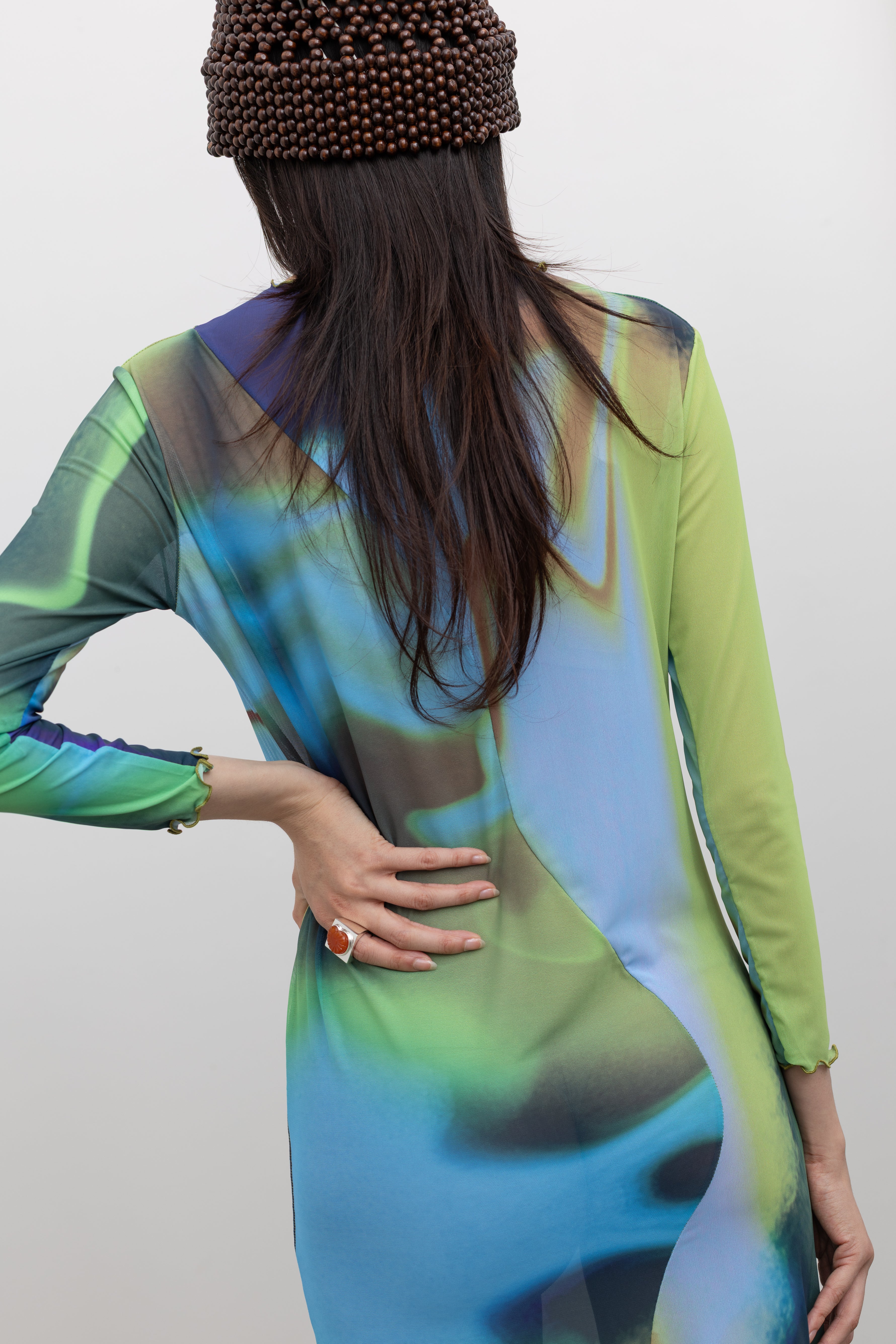 Back view of long sleeve midi dress highlighting Nin signature center curve and fitted silhouette at Alas Eius