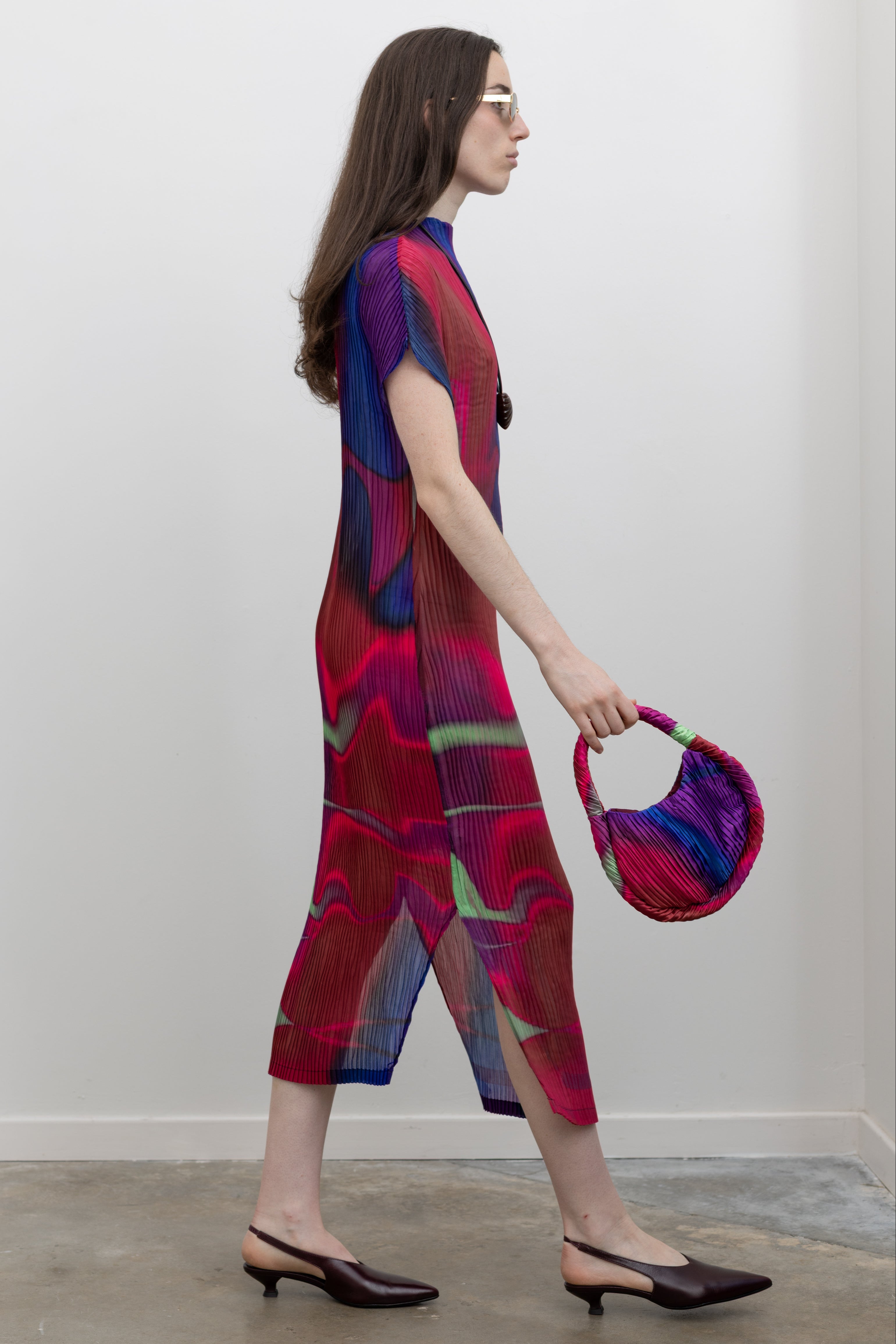 Nin Studio colorful pleated dress featuring sculptural detailing and flowing movement, a modern women's midi dress designed for elevated everyday style at Alas Eius