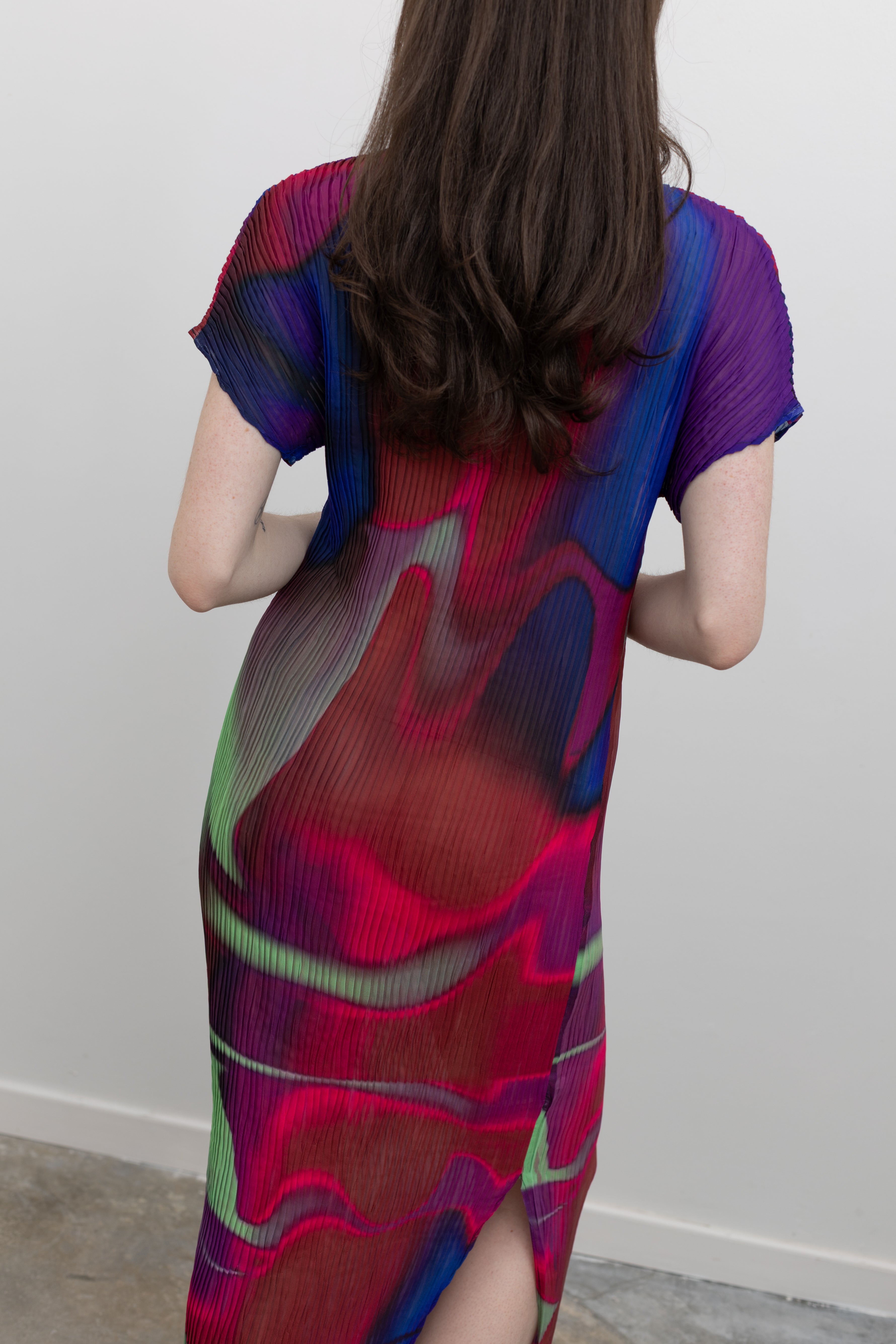 Nin Studio modern pleated midi dress showcasing vibrant color, dynamic movement, and architectural design, an eye-catching women's boutique fashion piece at Alas Eius