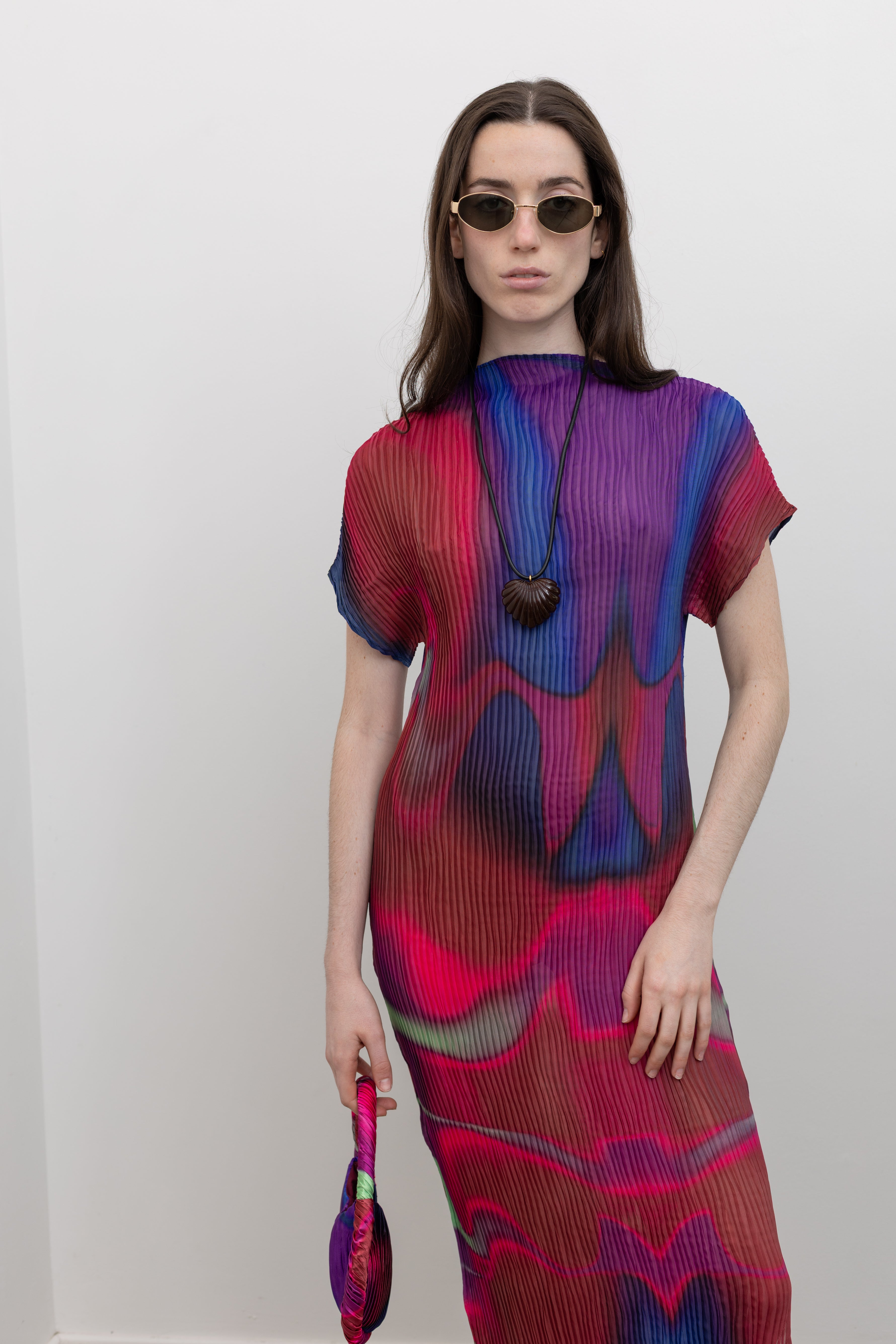 Nin Studio sculptural midi dress with signature pleated texture, side slit, and fluid drape, perfect for luxury women's clothing and contemporary wardrobe styling at Alas Eius
