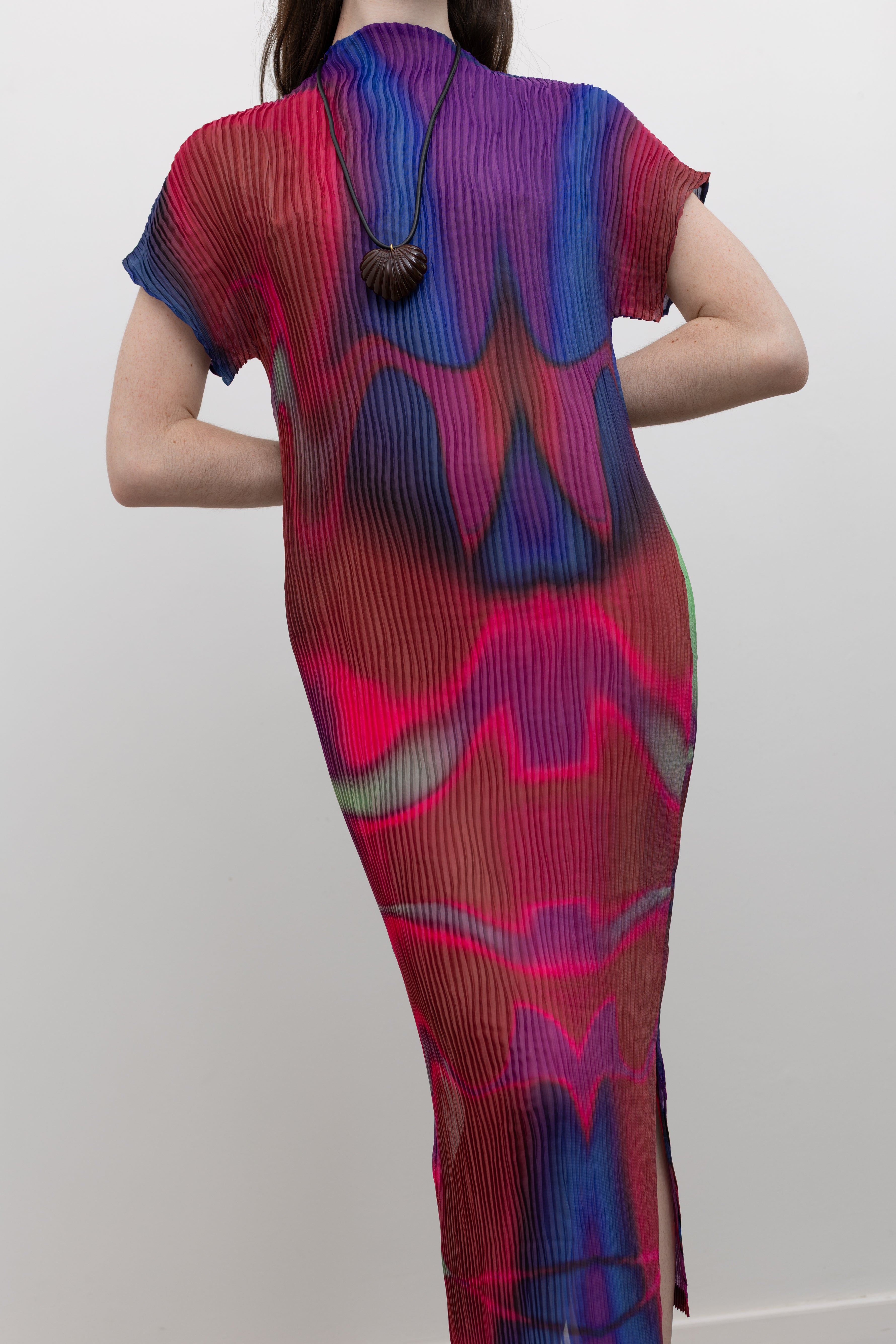 Nin Studio statement midi dress with signature wave pleats, open neckline, and side slit, blending contemporary women's fashion with effortless occasion dressing at Alas Eius
