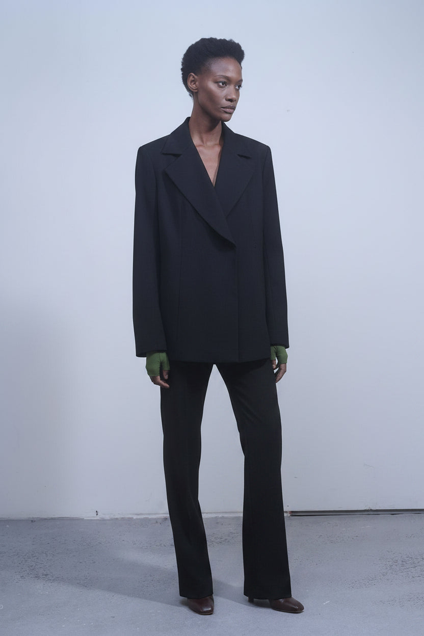Nomia black crepe double-breasted jacket with oversized silhouette and side slits at Alas Eius