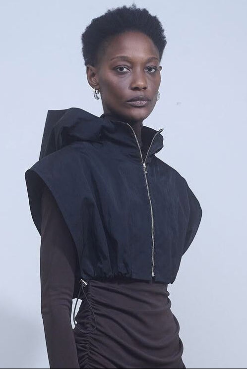 Nomia black cropped hooded pullover with sleeveless silhouette and bungee cord waist at Alas Eius