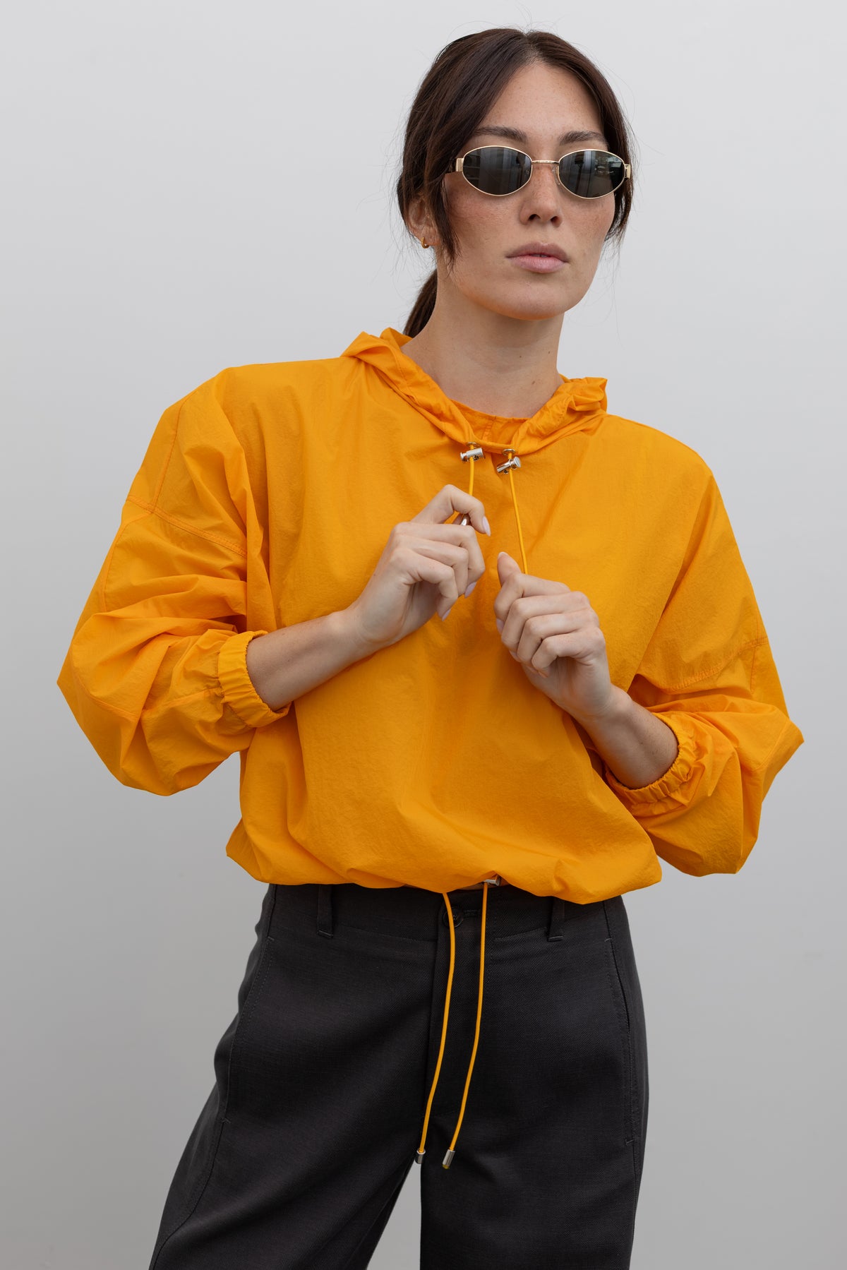 Nomia Tangerine Lightweight Translucent Hoodie, relaxed hooded pullover top, contemporary womenswear, at Alas Eius