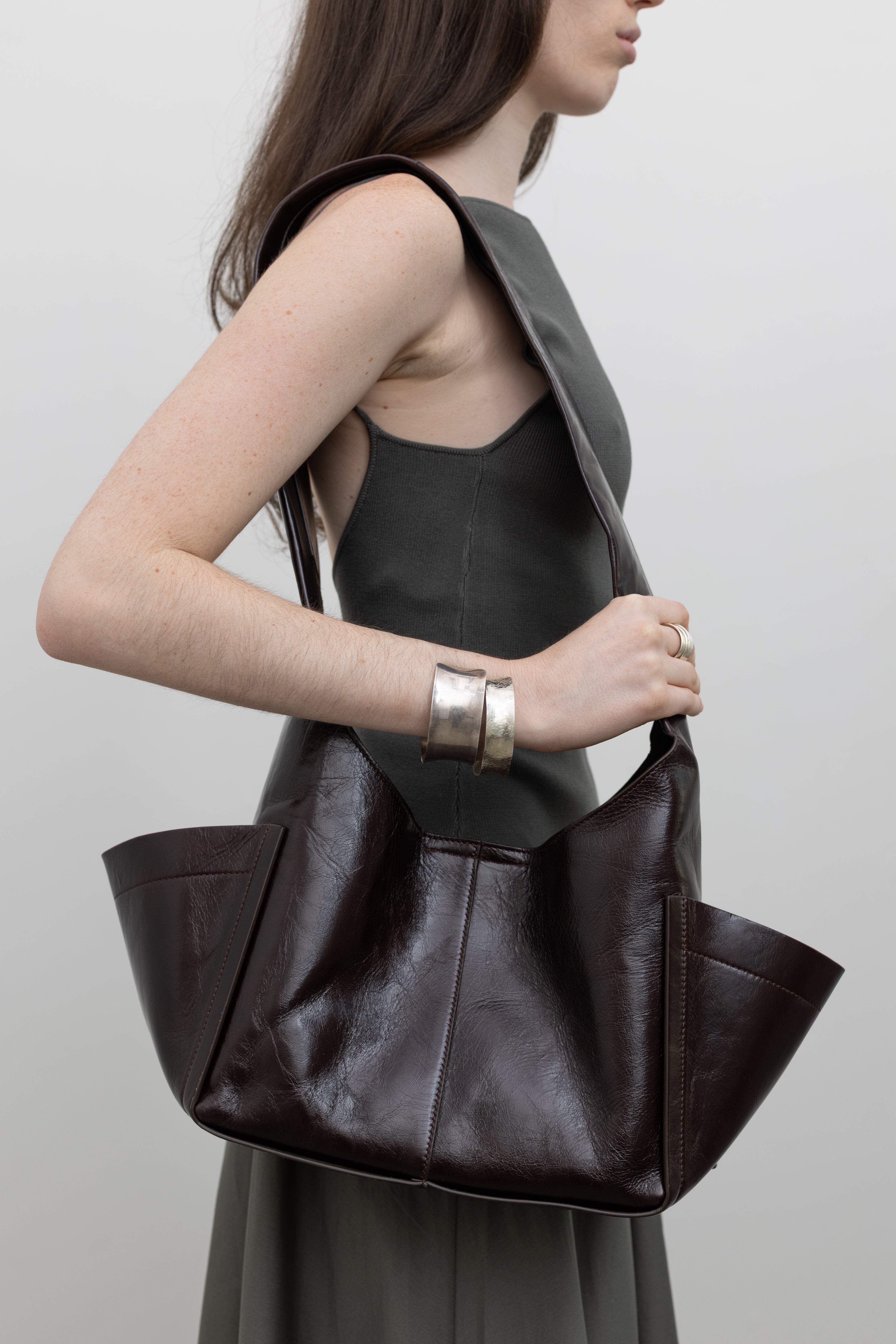 Rachel Comey semi-structured shoulder bag with sculptural silhouette and exterior pockets, styled for modern women's minimalist handbag fashion at Alas Eius