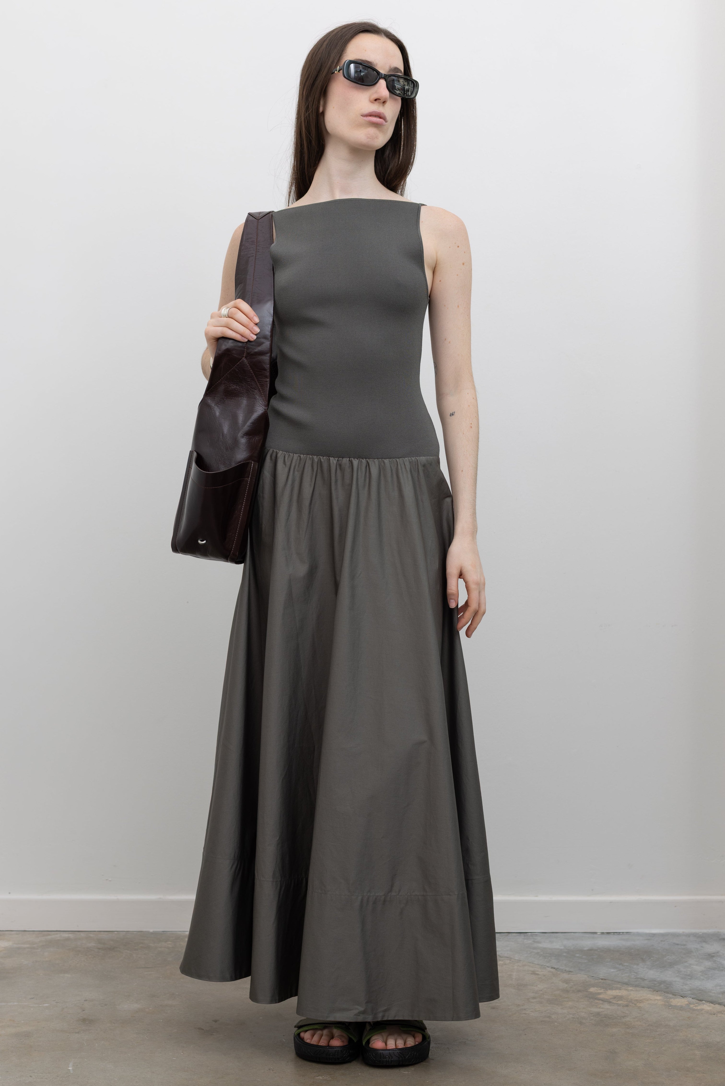 St. Agni backless dress with a fitted knit bodice, circle hem skirt, and elegant maxi silhouette at Alas Eius. 