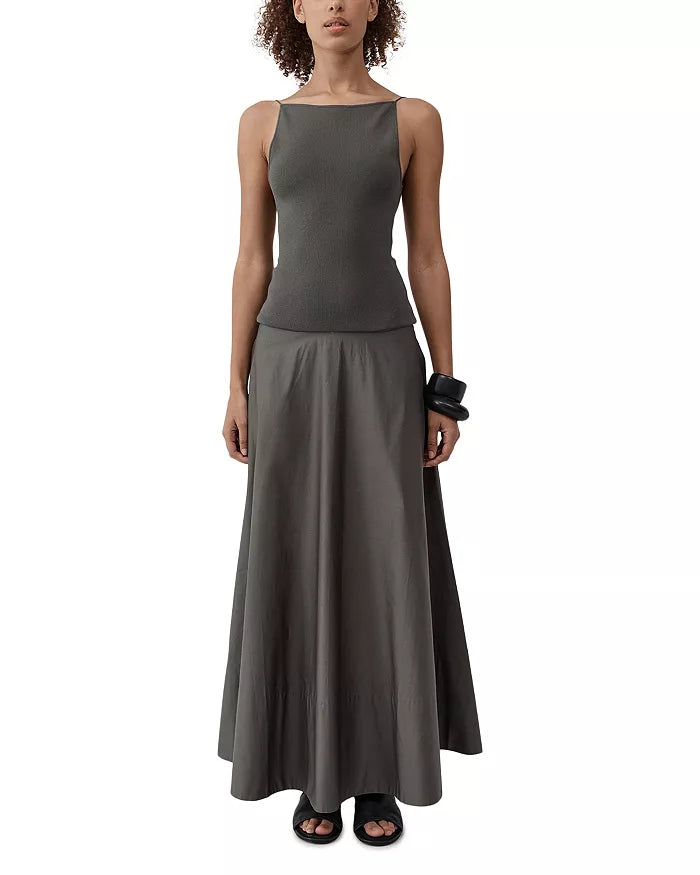 St. Agni elegant evening dress with a fitted knitted bodice, gathered waist, and dramatic open-back detail at Alas Eius. 