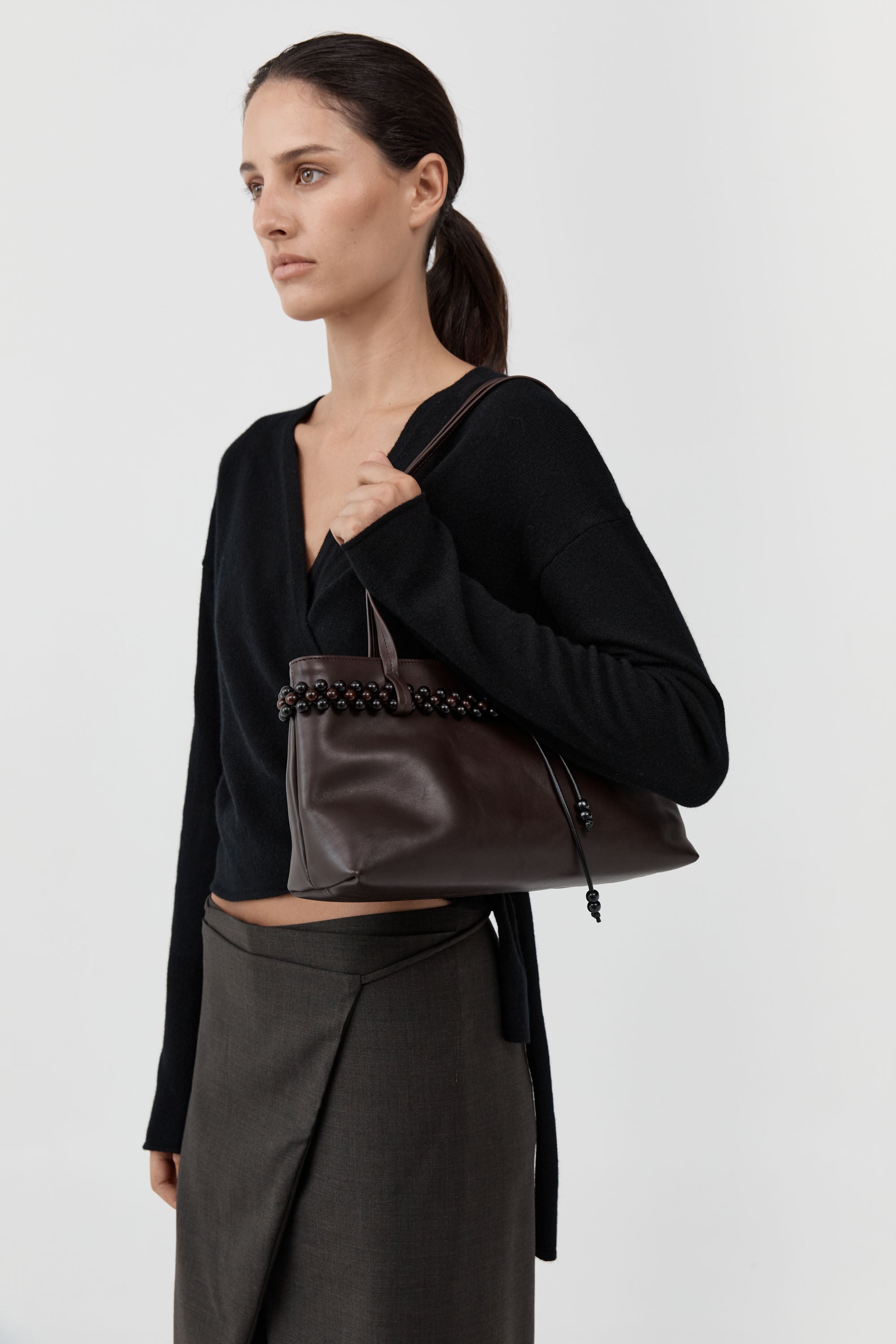 St. Agni minimalist leather baguette bag with magnetic closure at Alas Eius