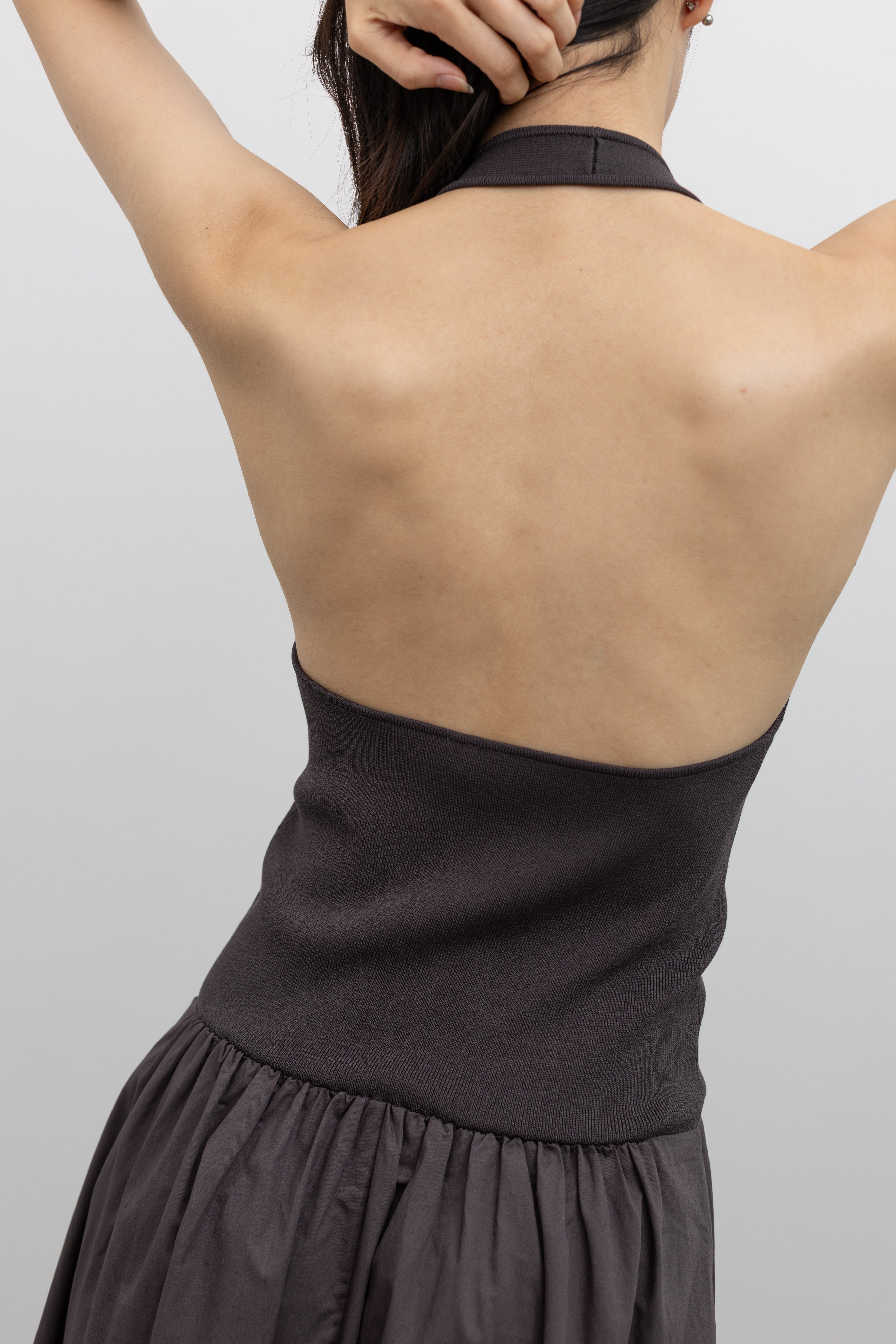 St. Agni minimalist halter dress combining a fitted knit bodice with a sweeping maxi skirt at Alas Eius. 