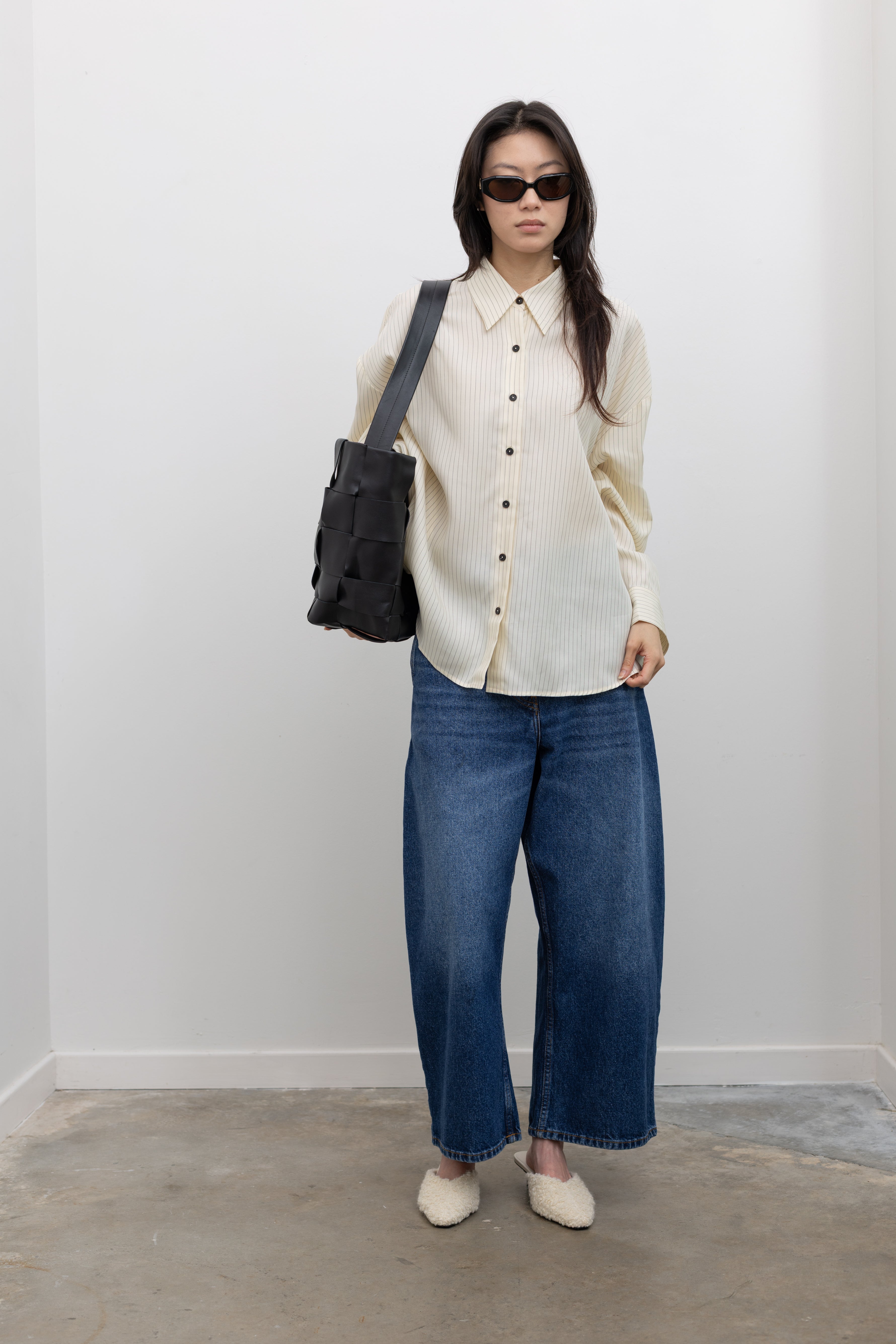St. Agni woven leather shoulder tote complementing contemporary women's capsule wardrobe essentials at Alas Eius