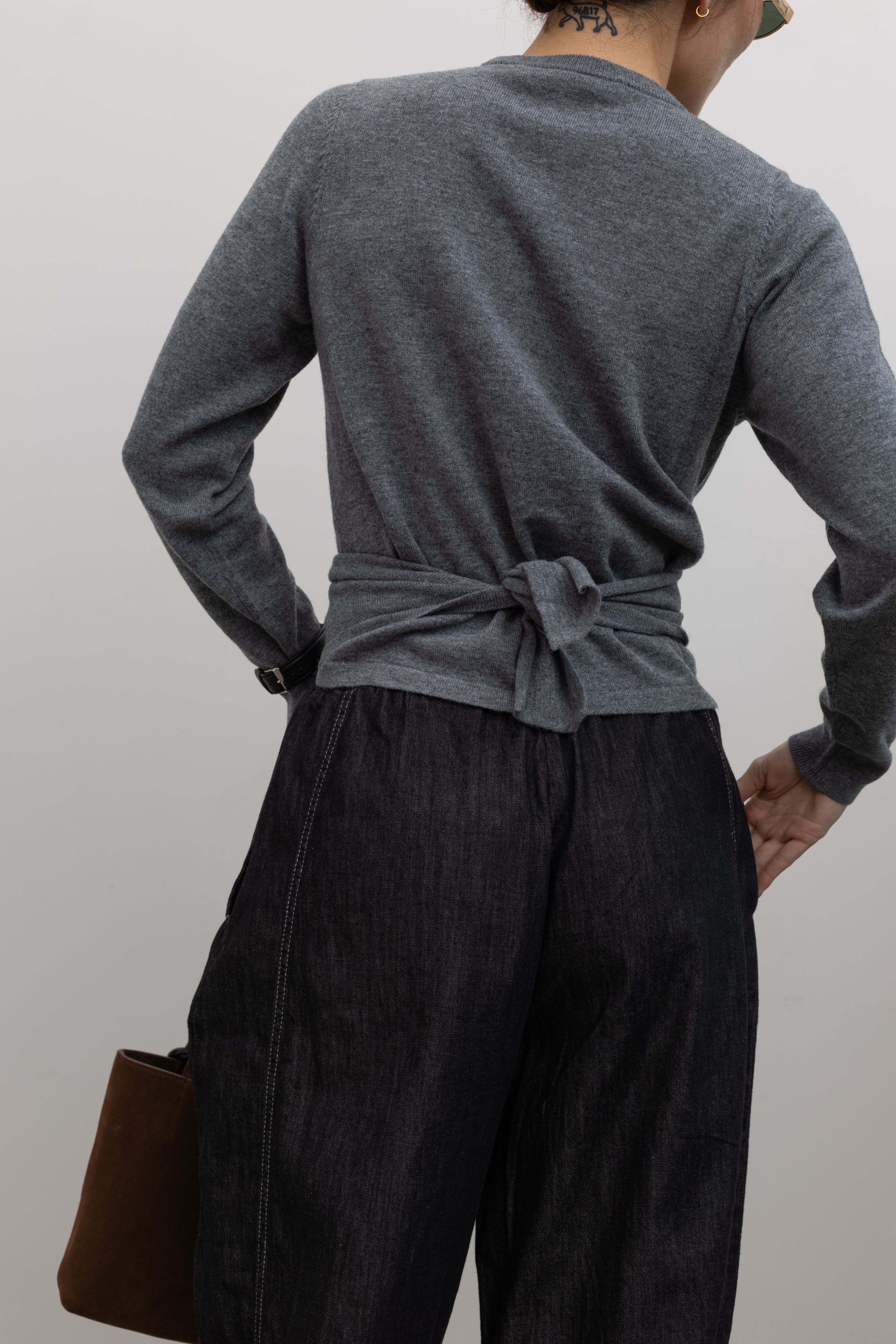 TELA feminine asymmetric wool sweater with gathered wrap silhouette at Alas Eius