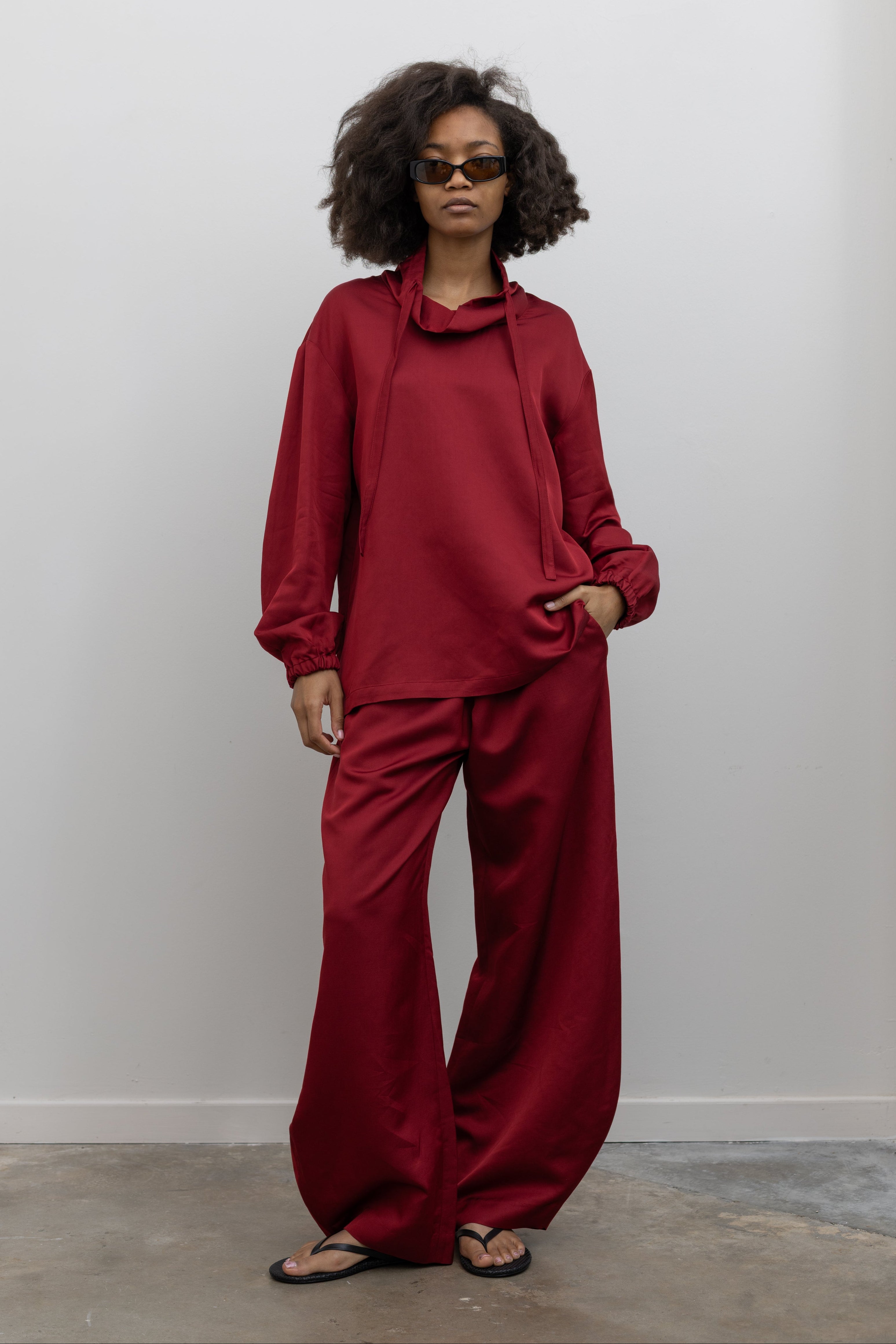Tela cherry red sweatshirt with a soft funnel neck, long sleeves, and relaxed silhouette at alas eius.