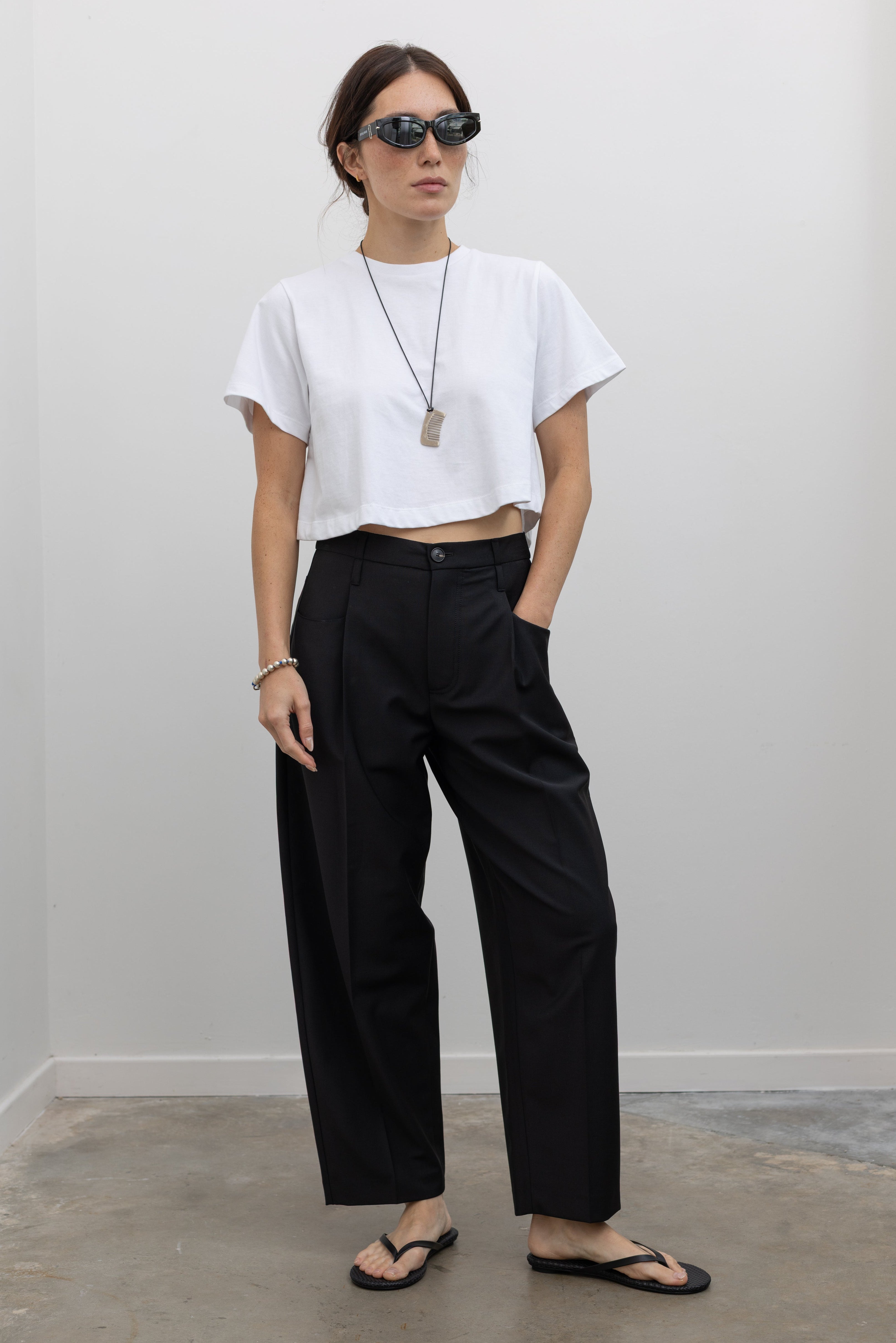 Tela Italian-made wool-blend trouser featuring a relaxed tailored silhouette and cropped ankle-length hem at alas eius.