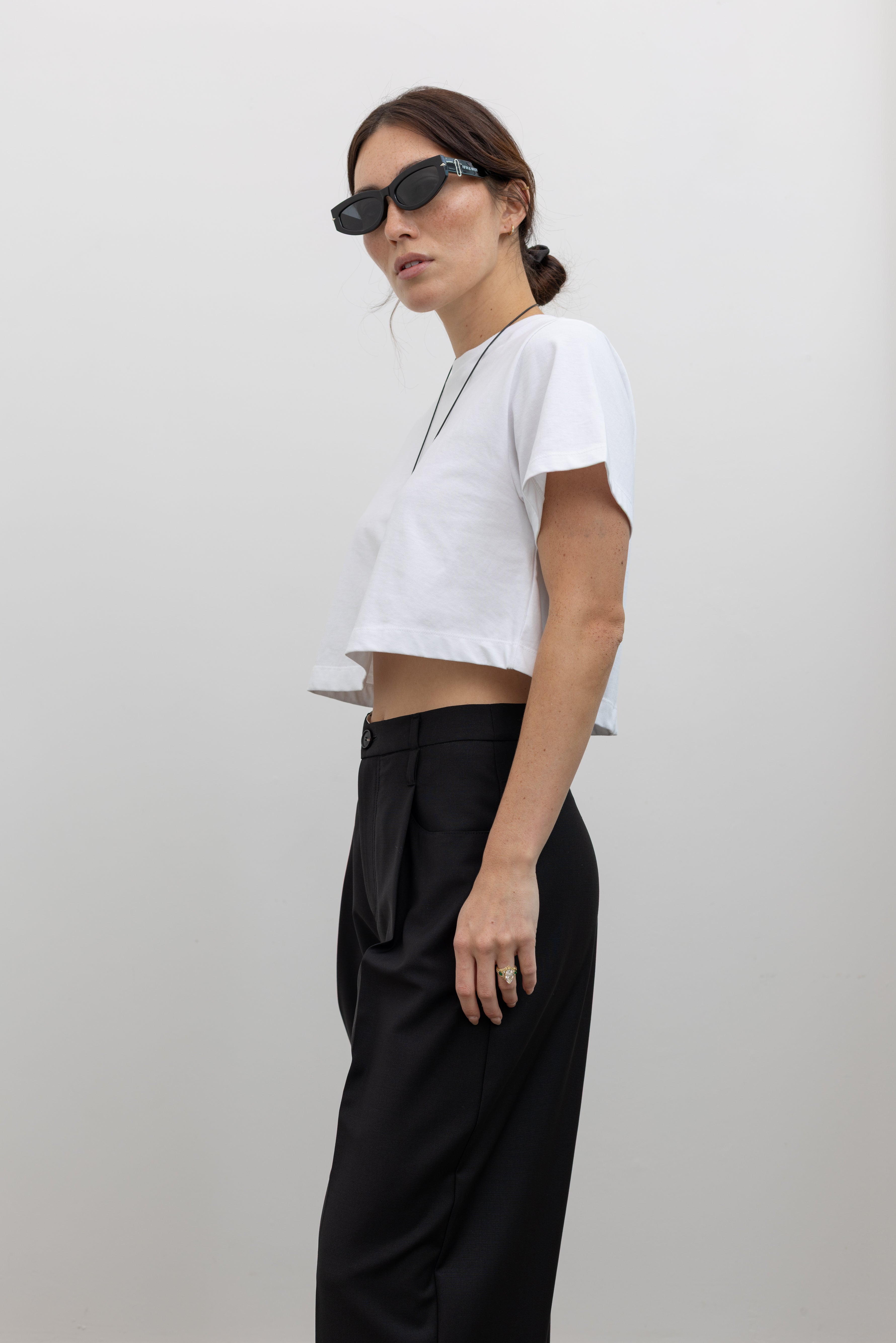 Tela tailored black pant crafted in Italy with elegant pleating and a fluid silhouette at alas eius.