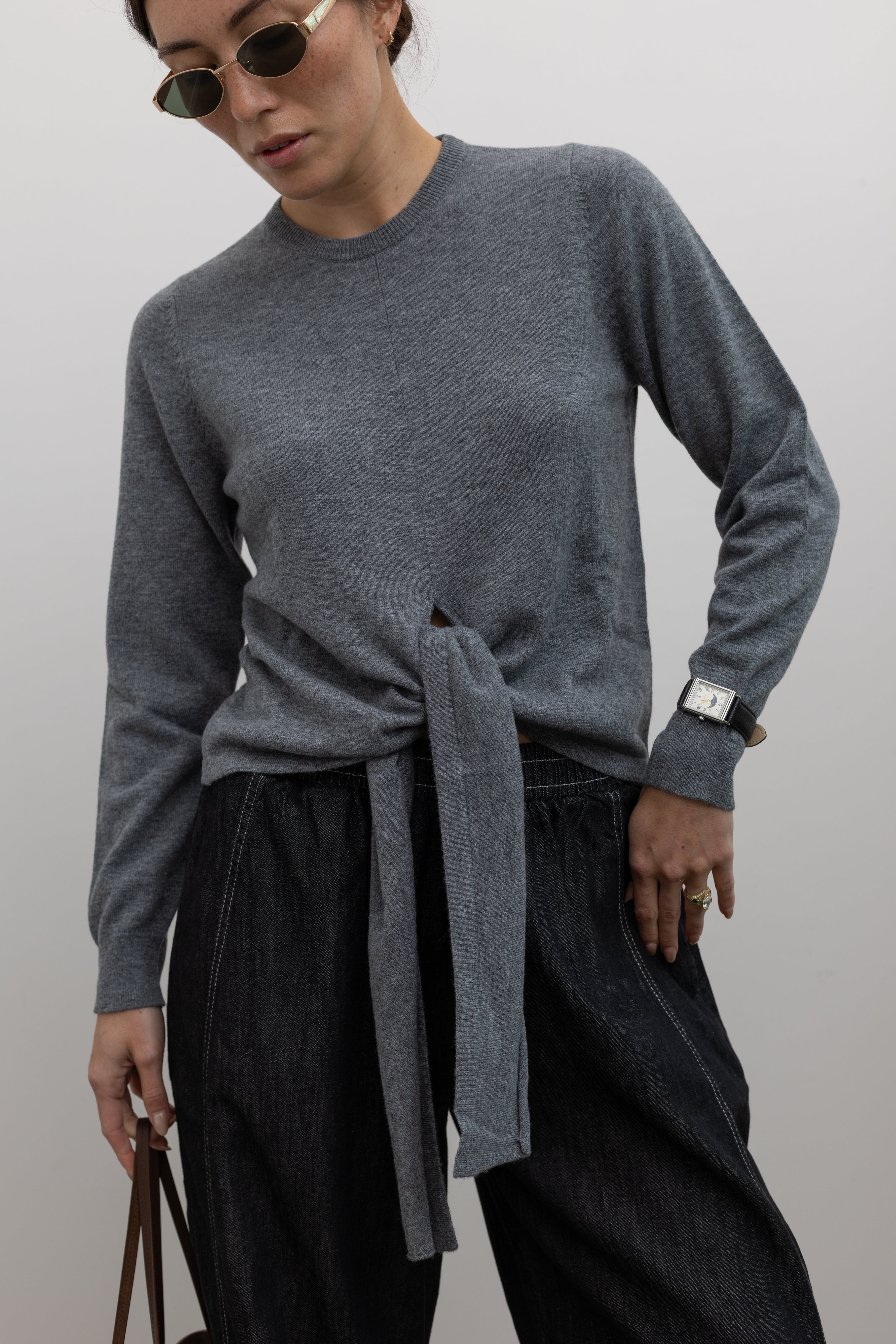TELA elevated wool wrap top with asymmetric design and long sleeves at Alas Eius