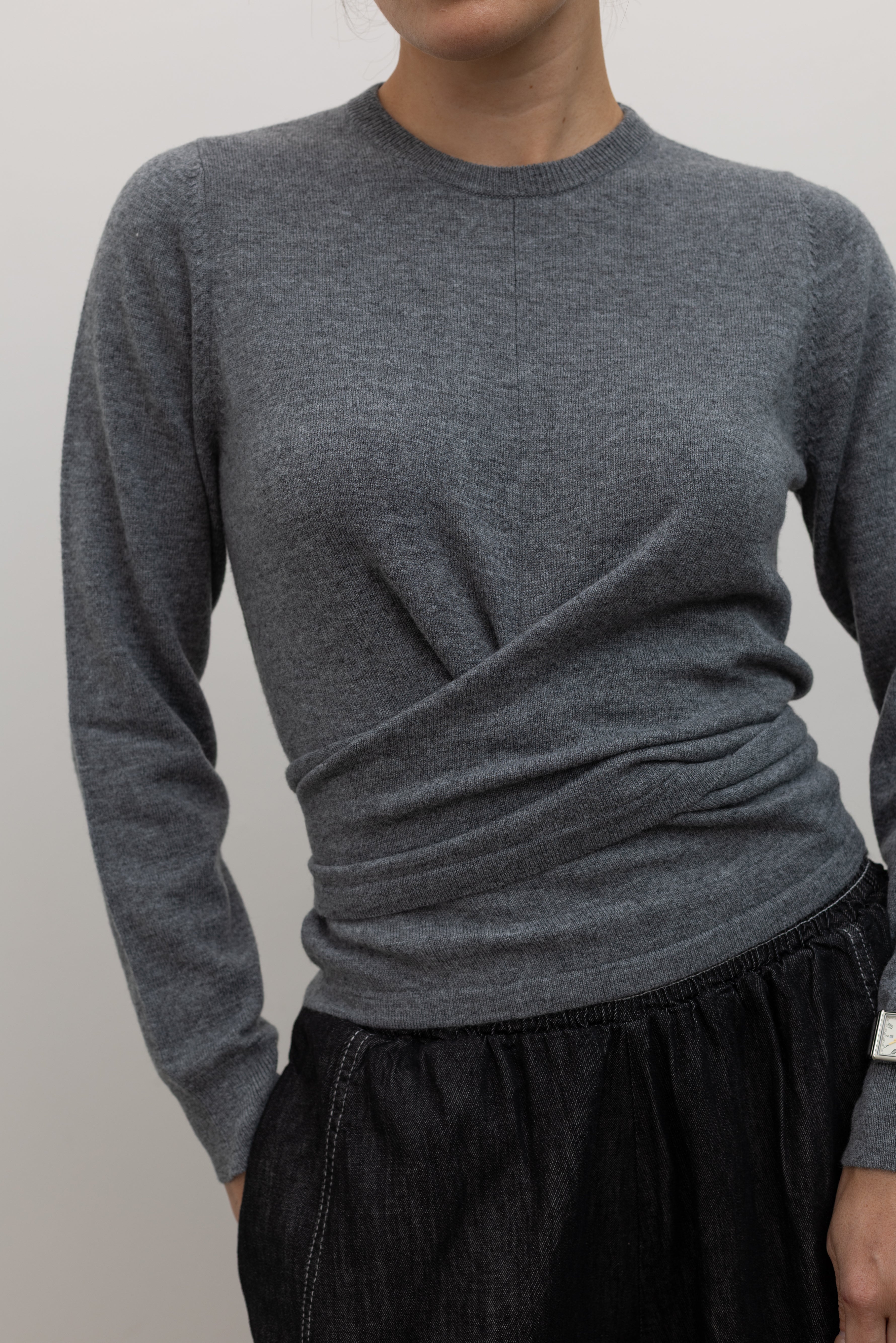 TELA minimal grey wool knit top with draped waist and back tie detail at Alas Eius