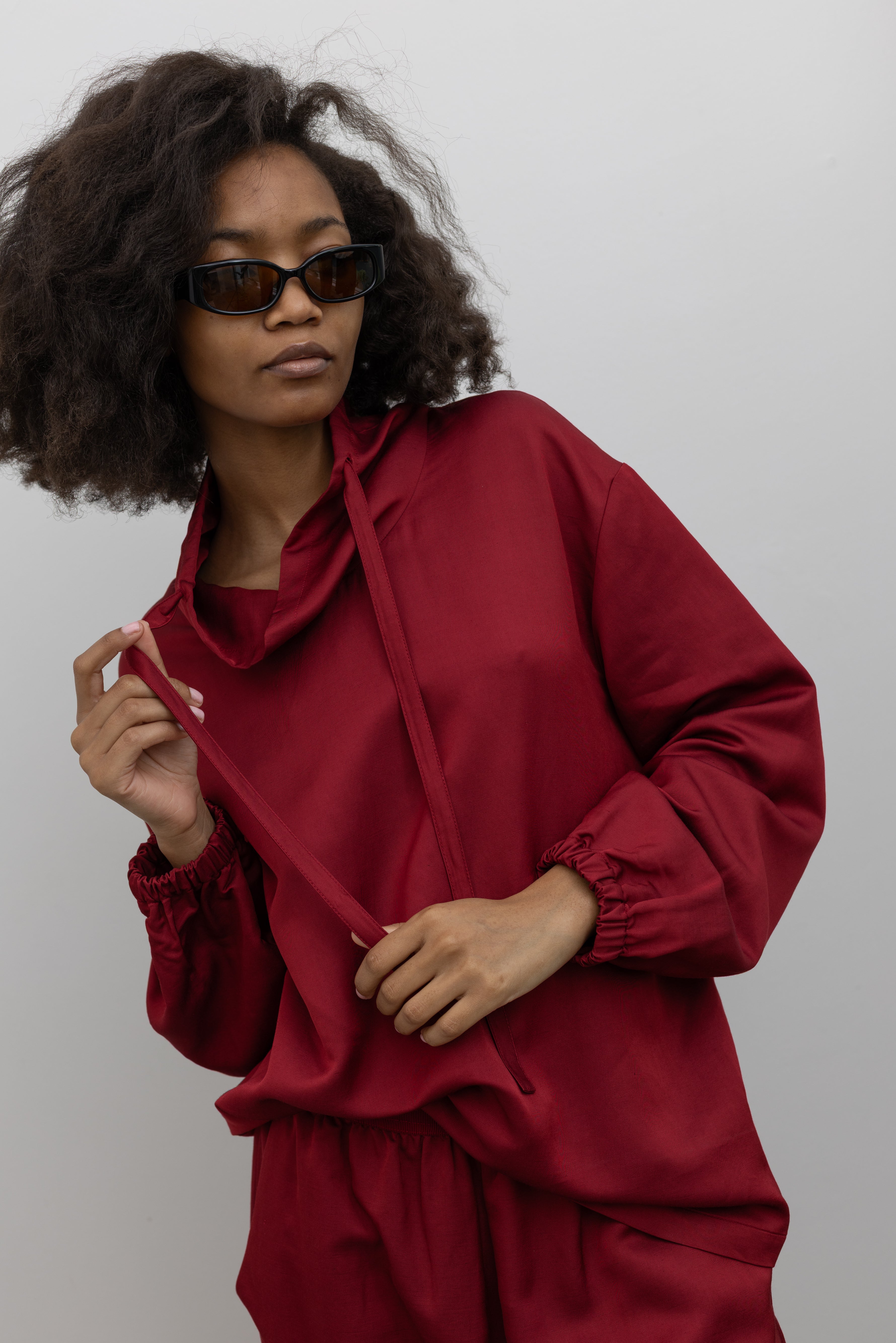 Tela Quota cherry red wool-linen blend sweatshirt featuring a relaxed fit, draped funnel neckline, and drawstring detail at alas eius.