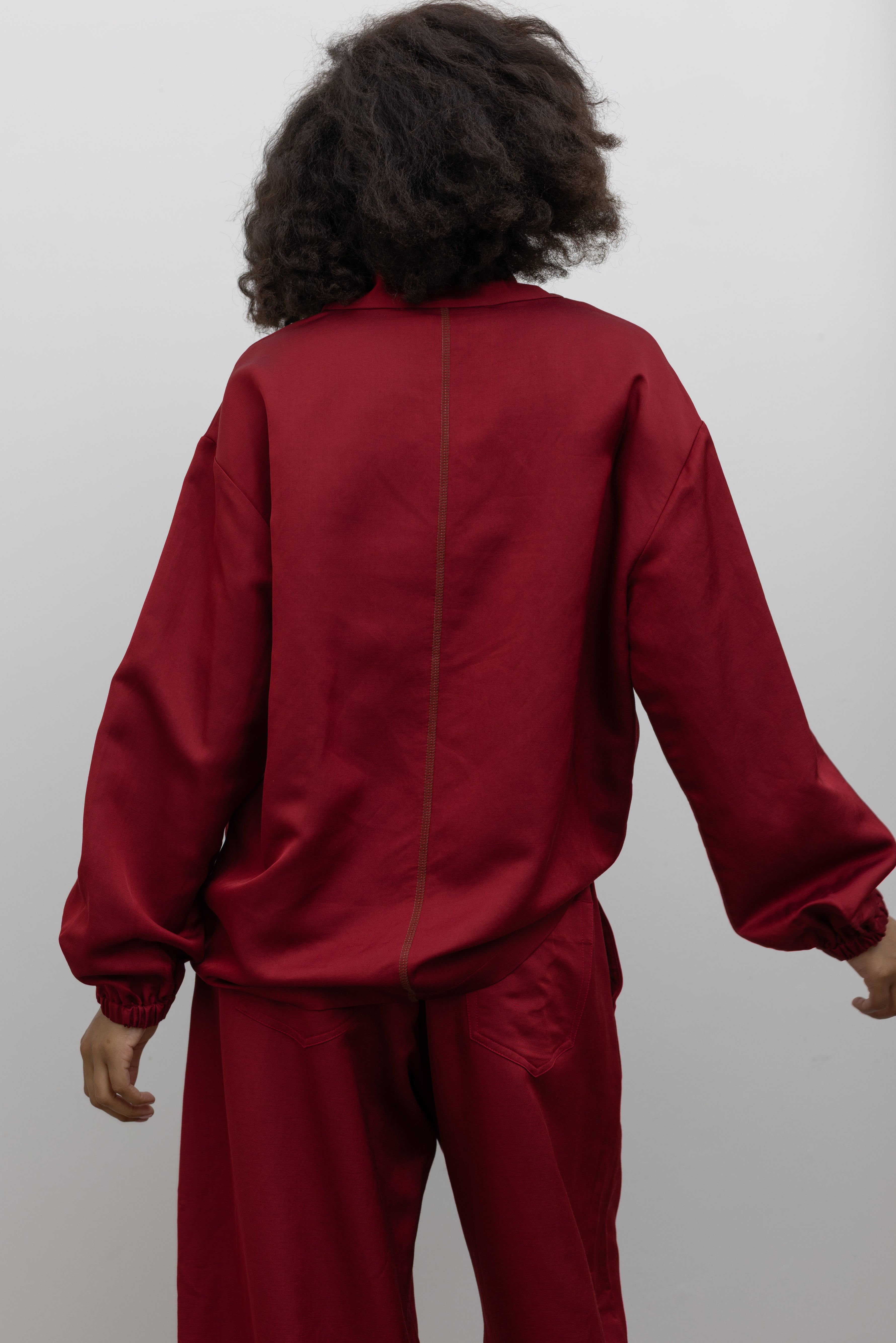 Tela elevated cherry red sweatshirt featuring a draped neckline and effortless oversized silhouette at alas eius.