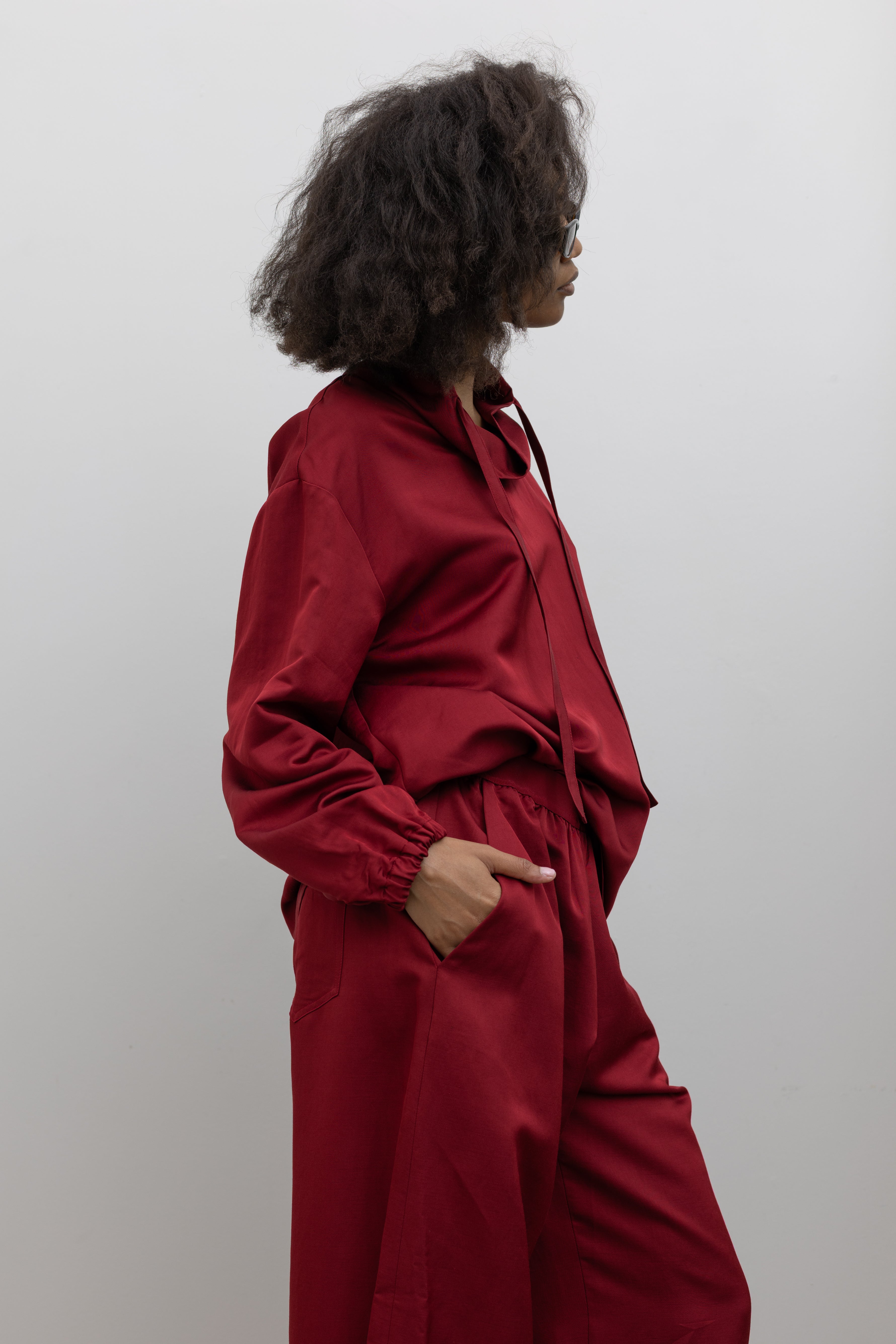 Tela cherry red wool-linen blend pullover styled with matching bottoms and a modern relaxed fit at alas eius.