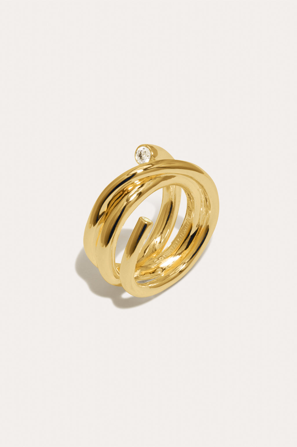 Completed Works Coil zirconia 18ct gold vermeil ring featuring two white zirconia stones in a sculptural wrap design at Alas Eius